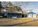 Charming blue home with a white porch and a two-car garage, perfect for comfortable living at 110 Fox Meadow Dr, Covington, GA 30016