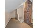 Finished attic featuring carpet, brick accent wall and stair access at 2597 Elsinore St, East Point, GA 30344