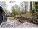 Picturesque backyard blending flagstone pathways with terraced garden beds, showcasing a home nestled within nature at 2597 Elsinore St, East Point, GA 30344