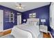 Comfortable bedroom with decor shelves, hardwood floors, and ample natural light at 2597 Elsinore St, East Point, GA 30344
