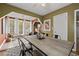 Open dining room leading to sunroom, featuring a rustic table and modern design at 2597 Elsinore St, East Point, GA 30344