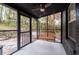 Inviting screened porch with a ceiling fan and a cozy wooden swing, perfect for relaxing at 2597 Elsinore St, East Point, GA 30344