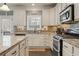 Kitchen boasts granite counters, stainless steel appliances, and white cabinets at 2671 Willow Field Se Xing # 14, Marietta, GA 30067