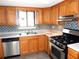 Oak kitchen with stainless steel appliances and tile backsplash at 2058 Powers Ferry Se Trce, Marietta, GA 30067