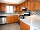 Oak kitchen with stainless steel appliances and tile backsplash at 2058 Powers Ferry Se Trce, Marietta, GA 30067