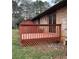 Backyard deck attached to brick home, featuring wood railings and a sliding glass door at 40 Chimney Rise Ct, Stockbridge, GA 30281