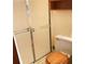 Bathroom featuring a toilet with wood seat, shower with sliding doors and a small storage shelf at 40 Chimney Rise Ct, Stockbridge, GA 30281