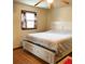 Bedroom featuring a window, hardwood floor, and a comfortable bed with storage underneath at 40 Chimney Rise Ct, Stockbridge, GA 30281