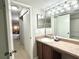 Bathroom with a double sink vanity and access to bedroom at 224 Seasons Pkwy, Norcross, GA 30093