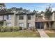 Attractive exterior of a condo building with landscaping and a walkway at 224 Seasons Pkwy, Norcross, GA 30093