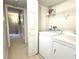 Bright laundry room with washer, dryer, and shelving at 224 Seasons Pkwy, Norcross, GA 30093