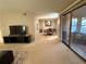 Spacious living room with a TV and access to a sunroom at 224 Seasons Pkwy, Norcross, GA 30093