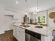 Open concept kitchen with island and stainless steel appliances at 8232 Walnut Hall Dr, Fairburn, GA 30213