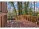 Outdoor deck surrounded by green trees and plants, with a red railing at 3284 Huntwood Dr, Decatur, GA 30034