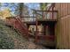 Multi-level deck and staircase with mature trees in a wooded backyard at 3284 Huntwood Dr, Decatur, GA 30034