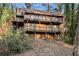 Multi-level home with exterior decks surrounded by lush greenery at 3284 Huntwood Dr, Decatur, GA 30034