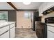 Kitchen featuring white cabinets, laminate countertops and black appliances at 3284 Huntwood Dr, Decatur, GA 30034