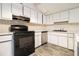 Kitchen with white cabinets, laminate countertops and black appliances at 3284 Huntwood Dr, Decatur, GA 30034
