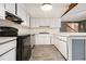 U-shaped kitchen featuring white cabinets, laminate countertops and black appliances at 3284 Huntwood Dr, Decatur, GA 30034