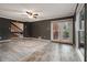 Living room featuring gray laminate floors, a ceiling fan and access to the backyard at 3284 Huntwood Dr, Decatur, GA 30034