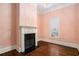 Charming bedroom featuring hardwood floors, fireplace, and large window at 159 Cedar Creek Rd, Cartersville, GA 30121