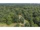 Aerial view of house on a wooded lot with long driveway at 416 Spring Place Ne Rd, White, GA 30184