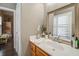 Bathroom with wood vanity, white sink and a large mirror at 416 Spring Place Ne Rd, White, GA 30184