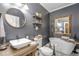 Elegant bathroom with freestanding tub, modern vanity, and decorative tile at 416 Spring Place Ne Rd, White, GA 30184