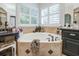 This bathroom features a soaking tub with jets and tile surround, as well as plenty of natural light at 416 Spring Place Ne Rd, White, GA 30184