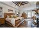 Main bedroom with hardwood floors, a large bed and a fireplace at 416 Spring Place Ne Rd, White, GA 30184