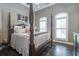 Spacious bedroom with hardwood floors and a large four poster bed at 416 Spring Place Ne Rd, White, GA 30184