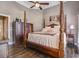 Bedroom with hardwood floors and a wooden four-poster bed at 416 Spring Place Ne Rd, White, GA 30184