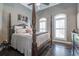 Spacious bedroom with hardwood floors and a large four poster bed at 416 Spring Place Ne Rd, White, GA 30184