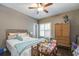 Bedroom showcasing hardwood floors, natural light from the windows, and a comfy bed creates a serene retreat at 416 Spring Place Ne Rd, White, GA 30184