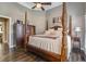 Bright bedroom featuring hardwood floors and a wooden four-poster bed at 416 Spring Place Ne Rd, White, GA 30184