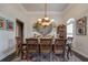 Elegant dining room featuring a large table, chandelier, and unique wall decor at 416 Spring Place Ne Rd, White, GA 30184