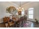 Spacious dining room with hardwood floors, large windows, and a rustic clock at 416 Spring Place Ne Rd, White, GA 30184