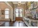 Bright entryway with double doors, hardwood floors, and decorative console table at 416 Spring Place Ne Rd, White, GA 30184
