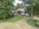 House with gray siding, brown accents, and a stone walkway at 416 Spring Place Ne Rd, White, GA 30184