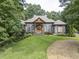 House with gray siding, brown accents, and stone details at 416 Spring Place Ne Rd, White, GA 30184