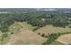 Wide-open farmland with a pond, barns, and houses at 416 Spring Place Ne Rd, White, GA 30184