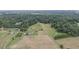 Vast farmland with a farmhouse, barn, and various structures at 416 Spring Place Ne Rd, White, GA 30184