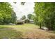 Luxury home with expansive backyard, detached garage, and tranquil wooded setting at 416 Spring Place Ne Rd, White, GA 30184