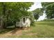Charming storage shed nestled in a lush green backyard at 416 Spring Place Ne Rd, White, GA 30184