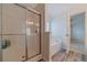 Bathroom featuring a glass-enclosed shower and soaking tub with wood-look flooring at 814 Sunny Field Ln, Lawrenceville, GA 30043