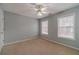 Neutral bedroom offers a ceiling fan and ample natural light from two windows at 814 Sunny Field Ln, Lawrenceville, GA 30043