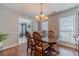 Formal dining room featuring hardwood floors, chair rail, and a view into the living room at 814 Sunny Field Ln, Lawrenceville, GA 30043