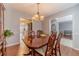 Dining room with hardwood floors and view of the kitchen, hallway and adjacent living area at 814 Sunny Field Ln, Lawrenceville, GA 30043
