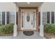 Inviting front entry featuring a white door with decorative glass, flanked by sidelights and brick accents at 814 Sunny Field Ln, Lawrenceville, GA 30043