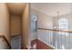 Bright second-story hallway with wood floors and natural light from window at 814 Sunny Field Ln, Lawrenceville, GA 30043